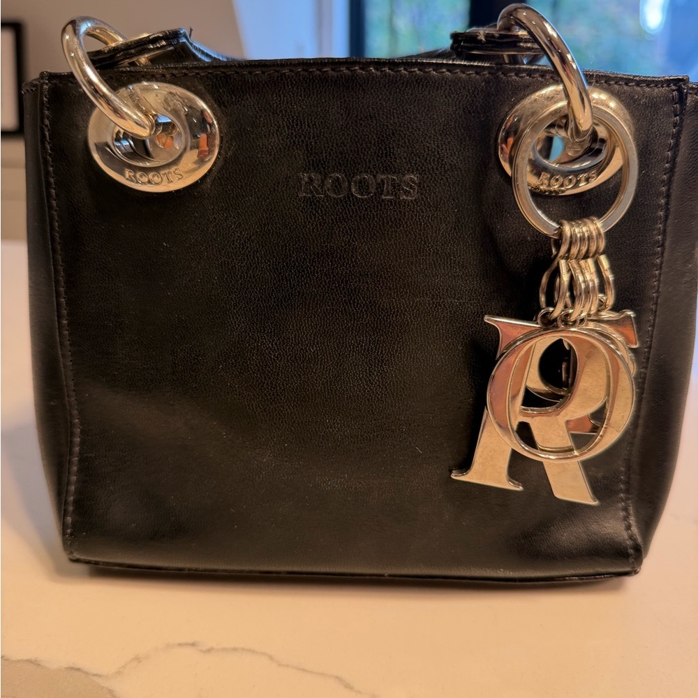 Vintage Roots Black Leather Handbag with Silver Accents.